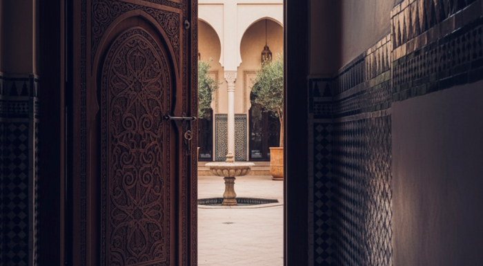 Ornate door opening to a courtyard fountain